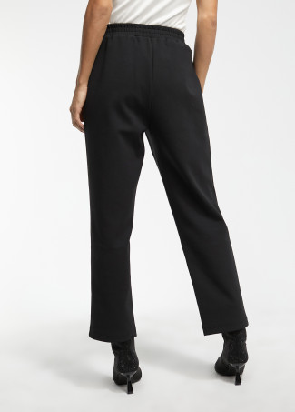 Pantalón de punto y efecto piel