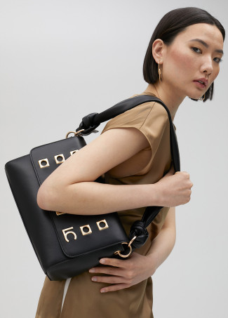 Crossbody bag with square metal eyelets