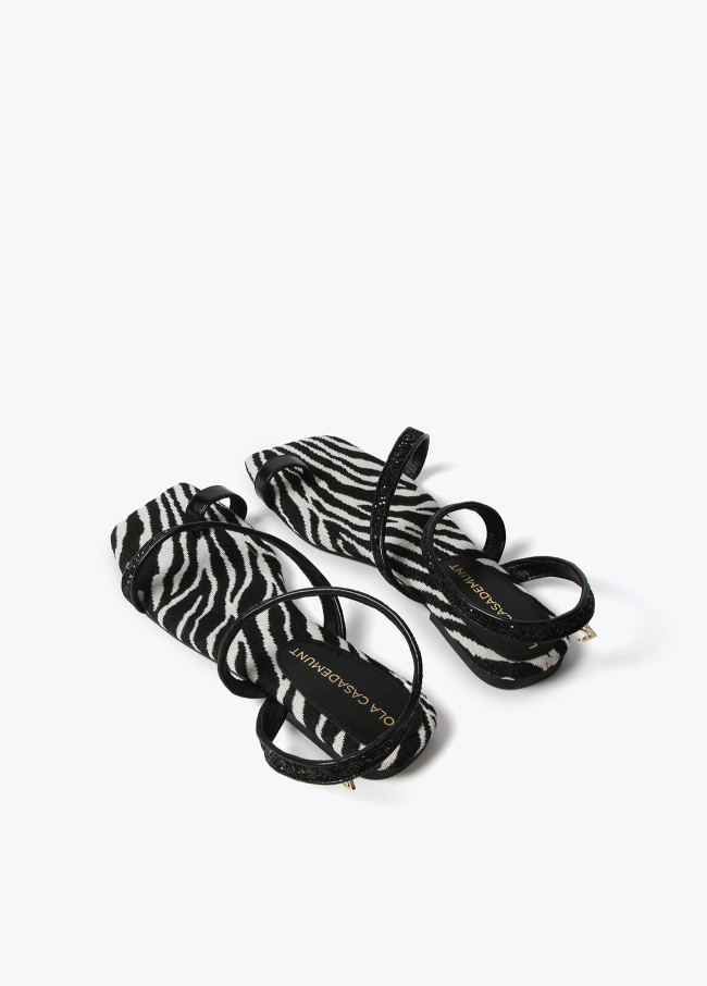 Metallic strappy sandals with zebra print insole.