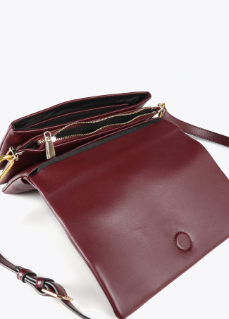 Faux leather crossbody bag with three compartments and flap.