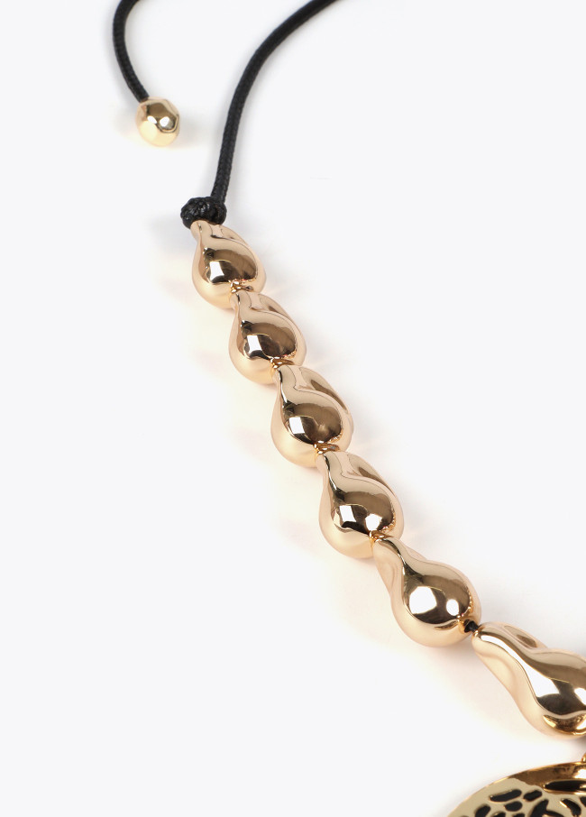 Cord necklace with golden pieces and rhinestone...