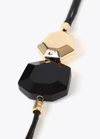 Cord necklace with contrast geometric pieces
