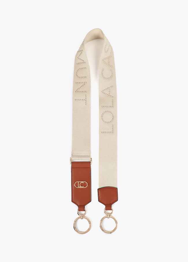 Bag strap with metallic studs and logo