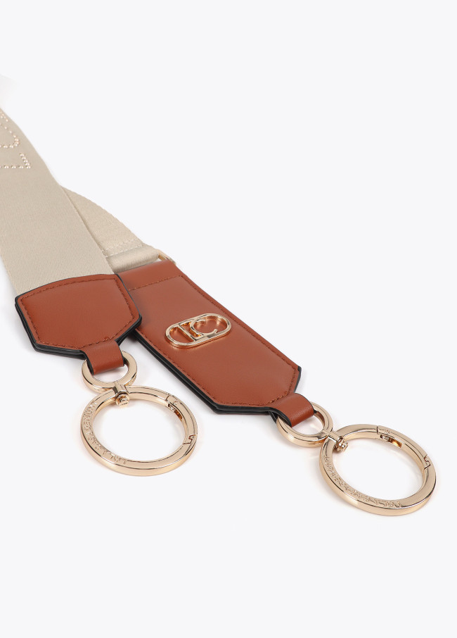 Bag strap with metallic studs and logo