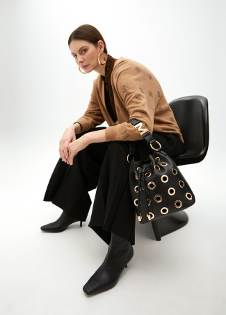 Pouch bag with circular metallic eyelets