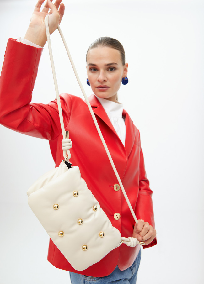 Quilted faux leather crossbody bag with round...