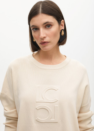 Round neck sweater with raised logo detail