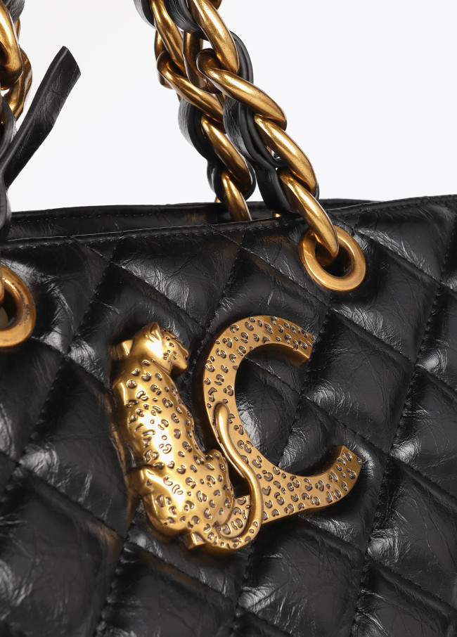 Quilted faux leather tote bag with chain strap...