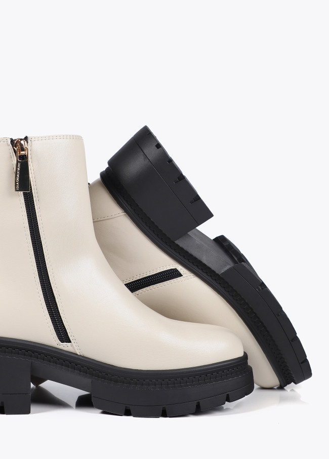 Ankle boots with track sole and strap with...