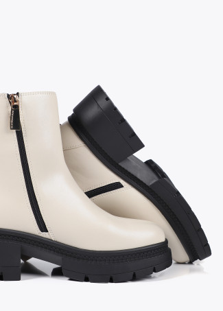 Ankle boots with track sole and strap with metal details