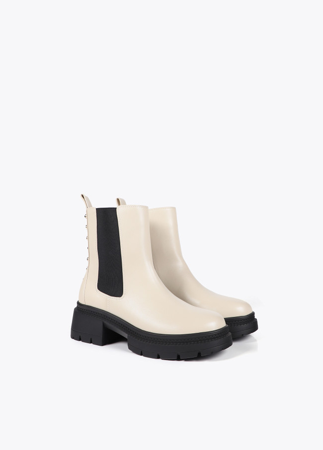 Ankle boots with track sole and strap with...