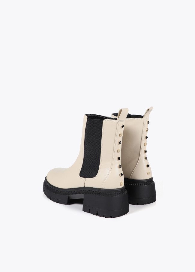 Ankle boots with track sole and strap with...