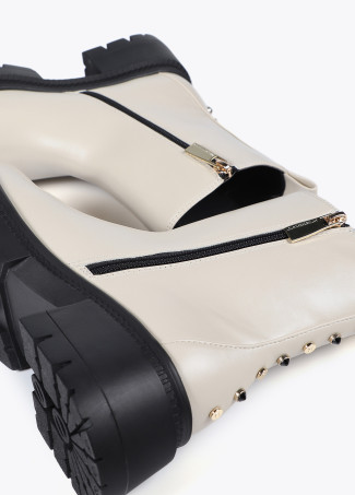 Ankle boots with track sole and strap with metal details