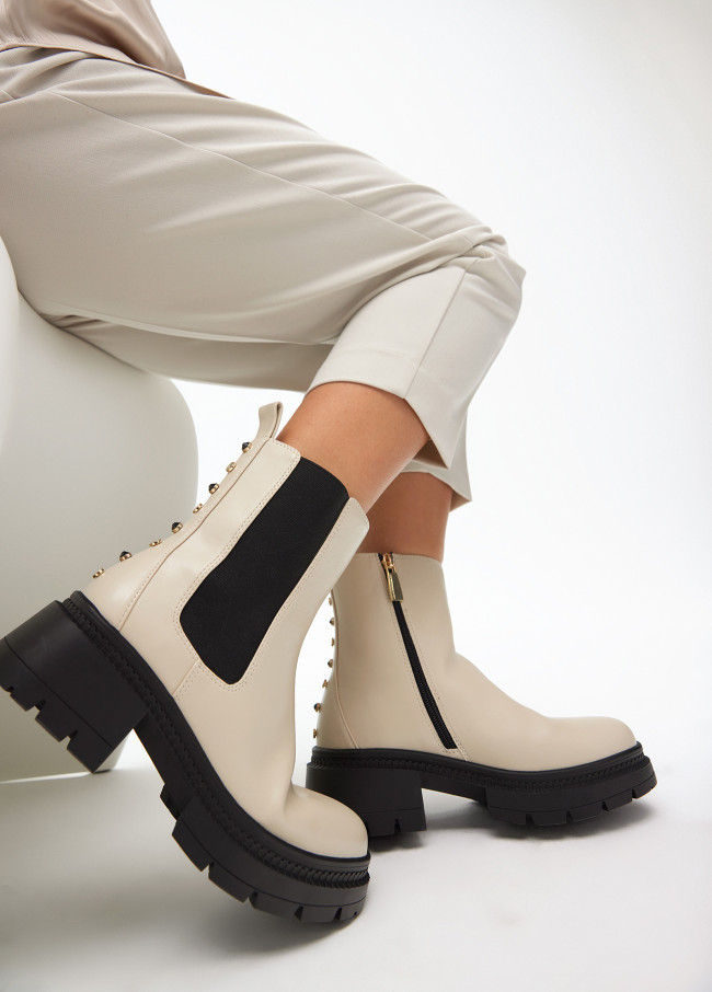 Ankle boots with track sole and strap with...
