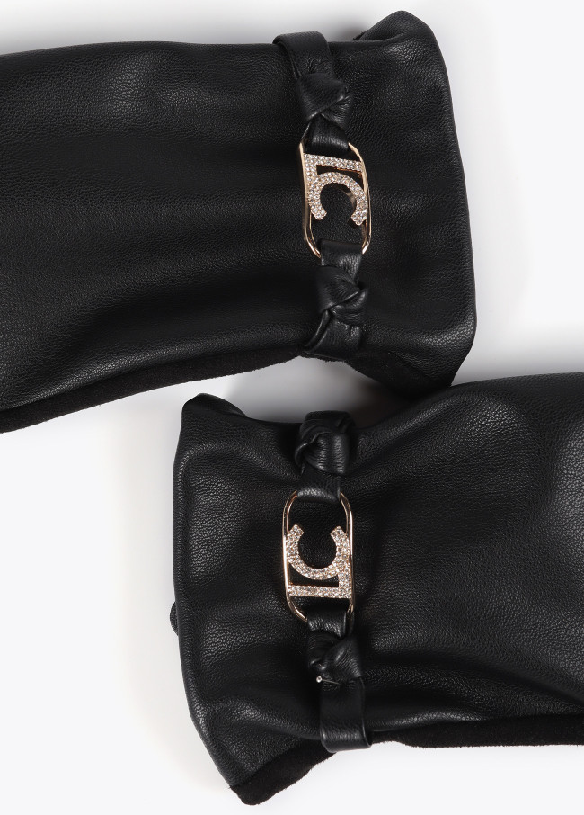 Faux leather gloves with wrist strap with oval...