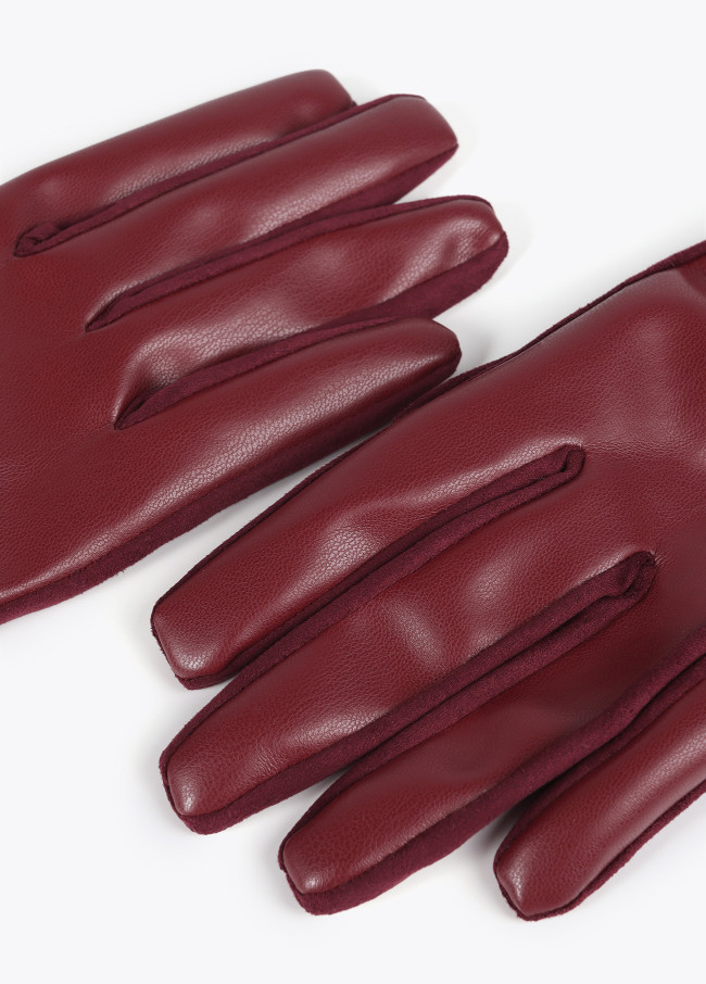 Faux leather gloves with wrist strap with oval...
