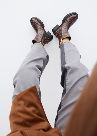 Animal print ankle boots with track sole and strap with metal details