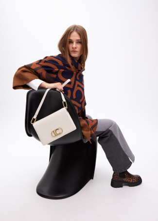 Faux leather crossbody bag with three compartments and flap.